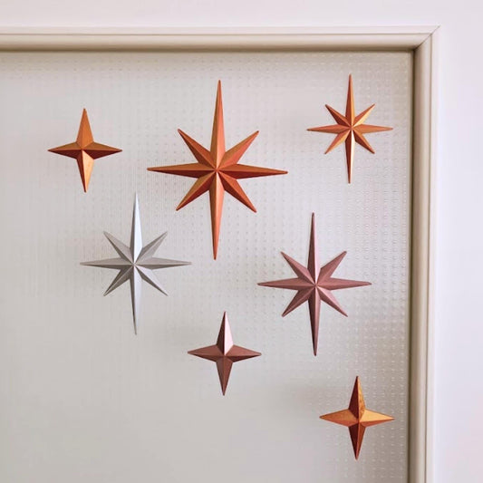 Starburst ornaments in warm metallic tones for retro holiday decor