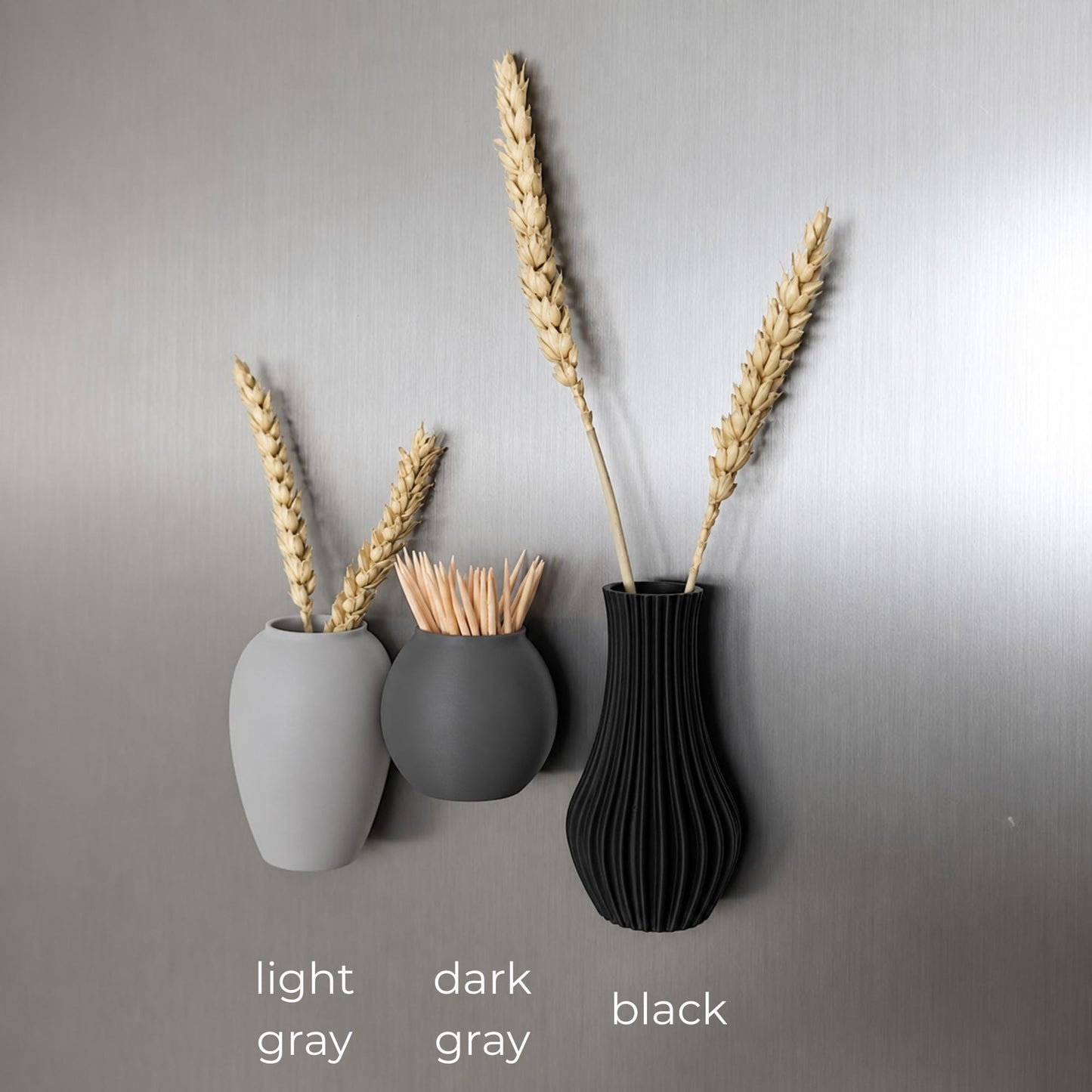 Three mini magnetic vases in various colors.