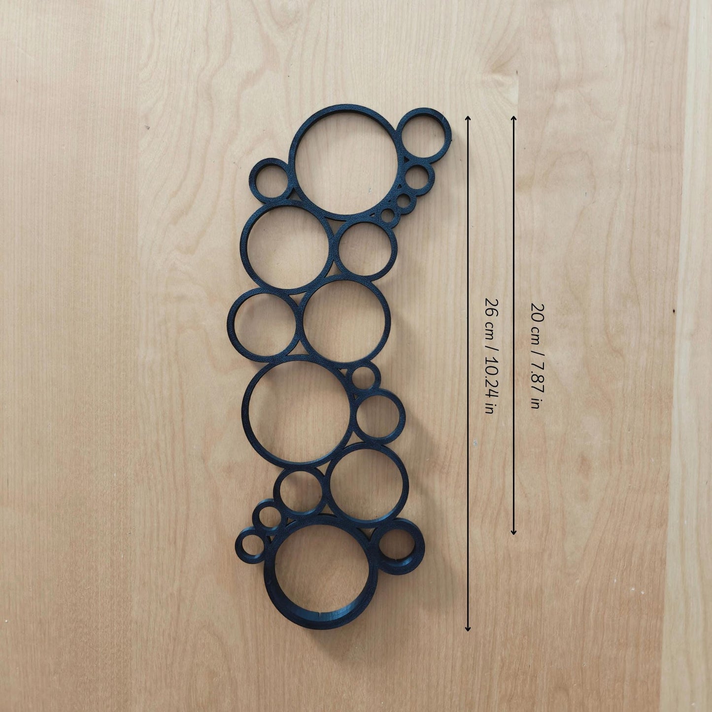 Single circular trellis extension placed on wooden surface with measurement labels