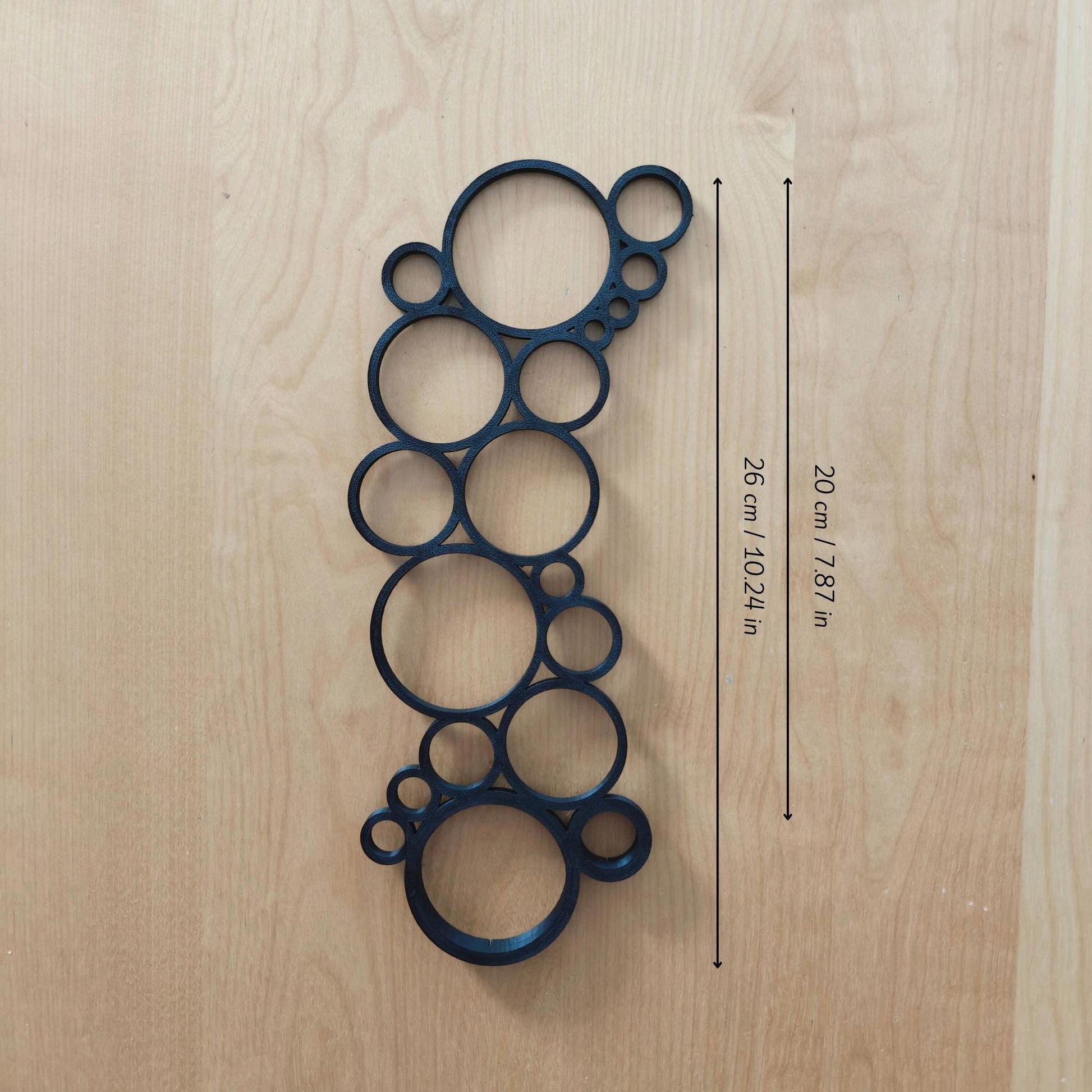 Single circular trellis extension placed on wooden surface with measurement labels