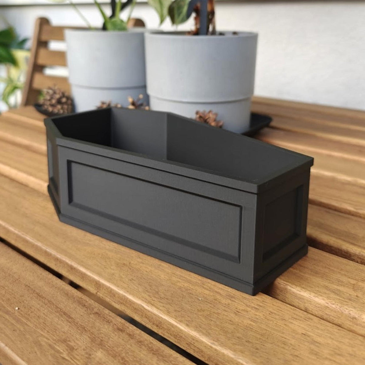 Empty coffin planter on table, decorative gothic plant container