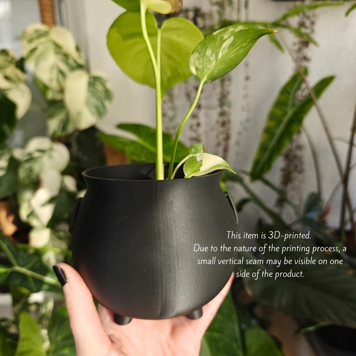 Black cauldron planter with text overlay noting that each item is 3D printed and minor variations and visible verical seams are normal due to the printing process.