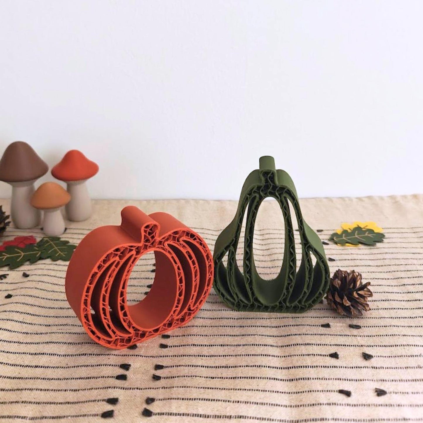Fall-themed table with 3D-printed pumpkin and gourd, acorns, and autumn leaves arranged decoratively.
