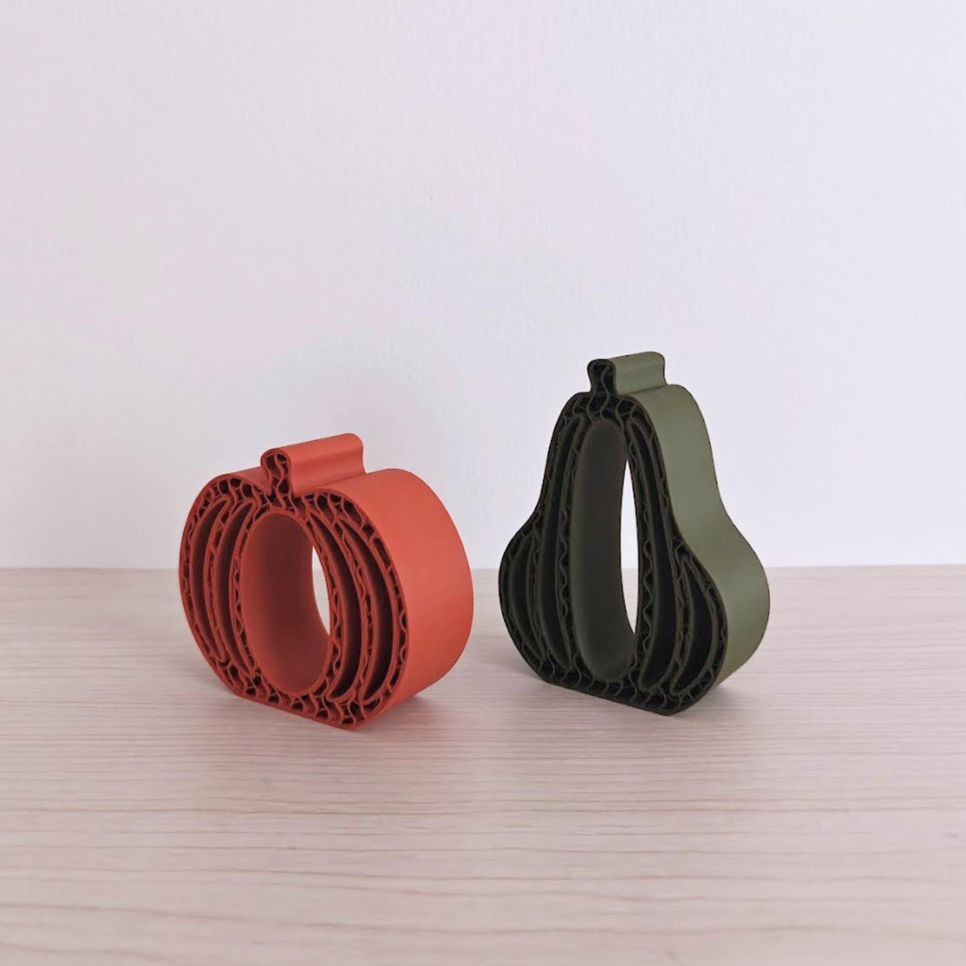 &lt;Side view of orange and green 3D-printed pumpkins and gourds displayed together on a neutral background.