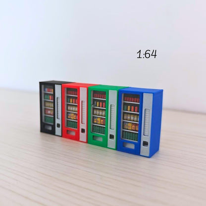 Four 1:64 scale miniature vending machines in blue, green, red, and black arranged in a row on a light wooden background. Each has visible painted snacks and drinks behind clear plastic panels.