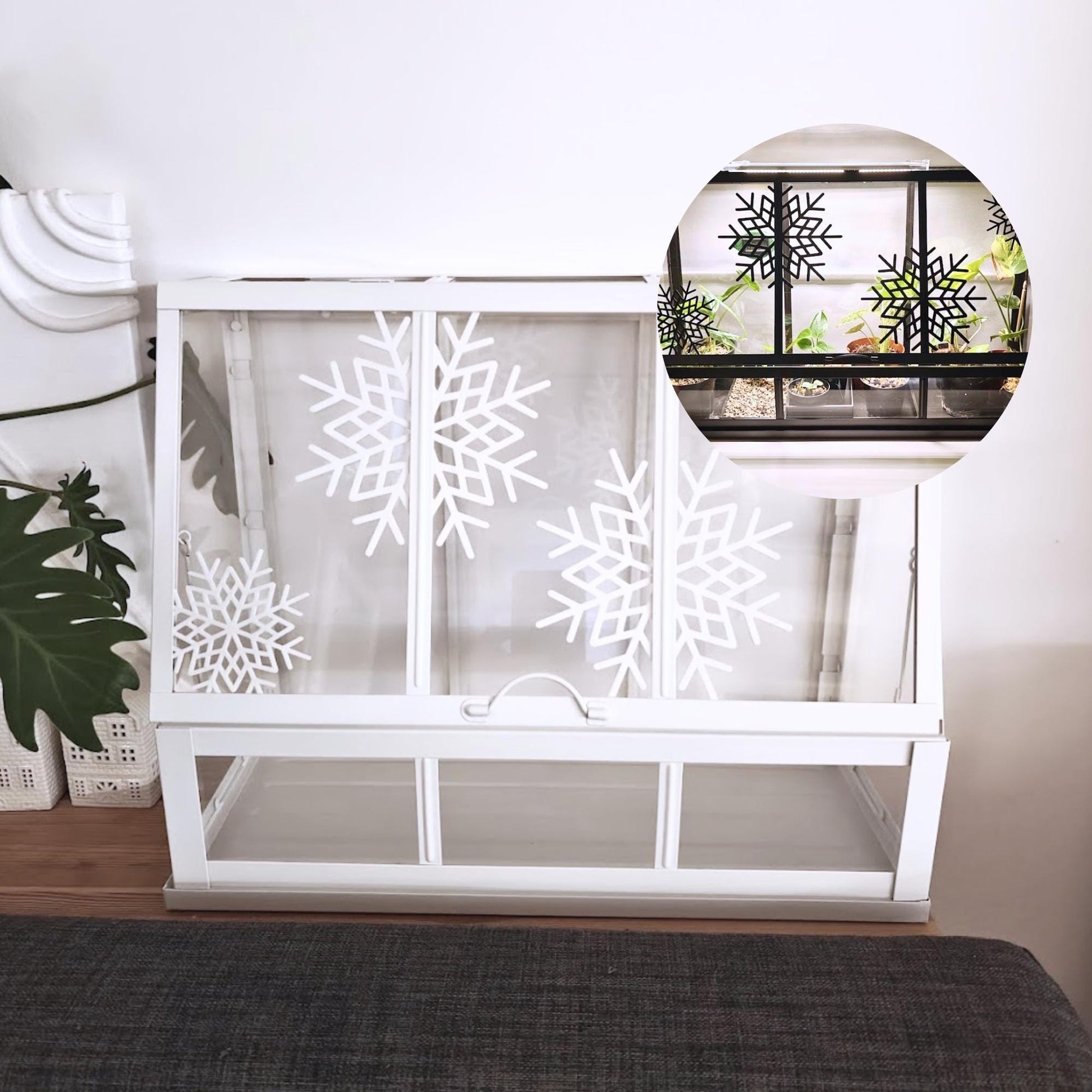 White Äkerbar greenhouse decorated with large white snowflake ornaments on glass panels.