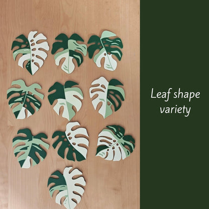 Various Monstera leaf coaster shapes displayed on table.