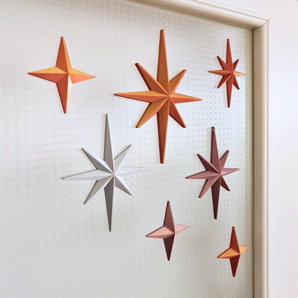 Starburst ornaments in warm metallic tones for retro holiday decor