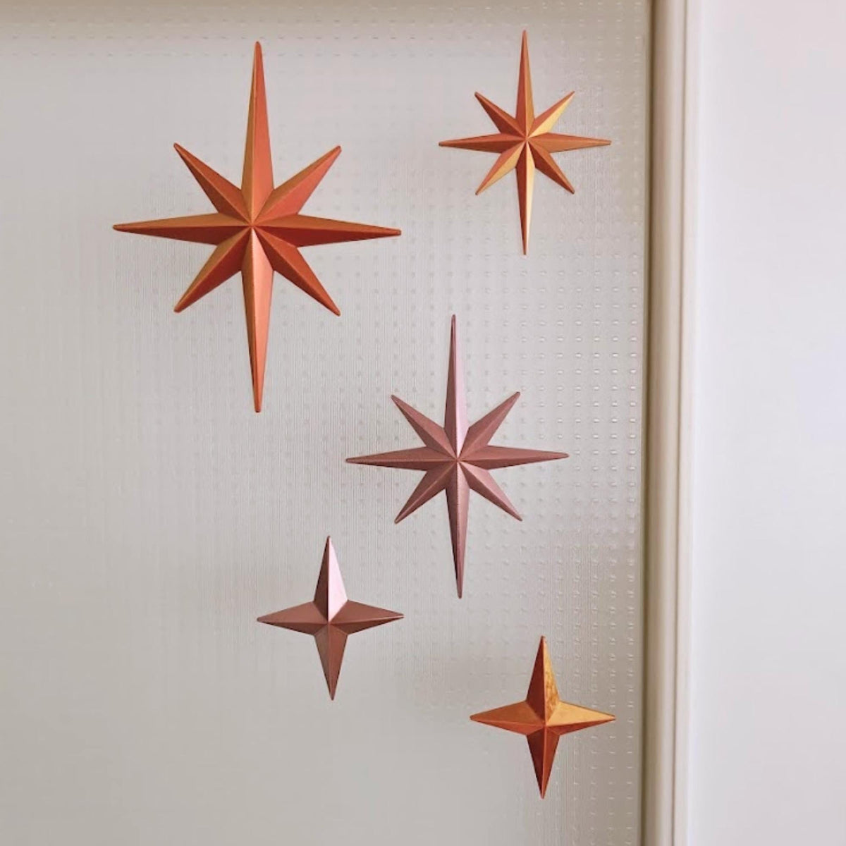 Starburst ornaments in warm metallic tones for retro holiday decor