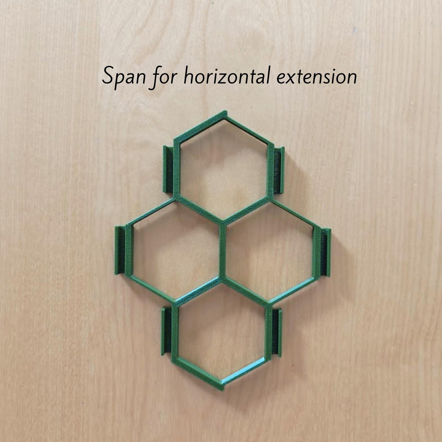 Single honeycomb trellis section with dimensions on wooden background