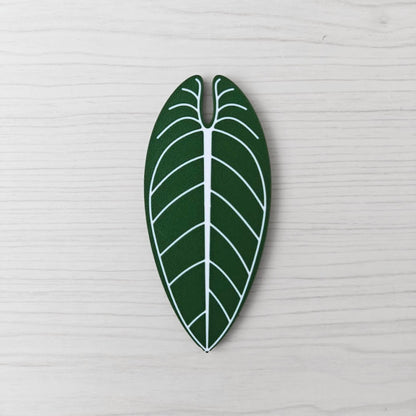 Front view of the Anthurium Warocqueanum key cover handle with white vein detail on a light wood background.
