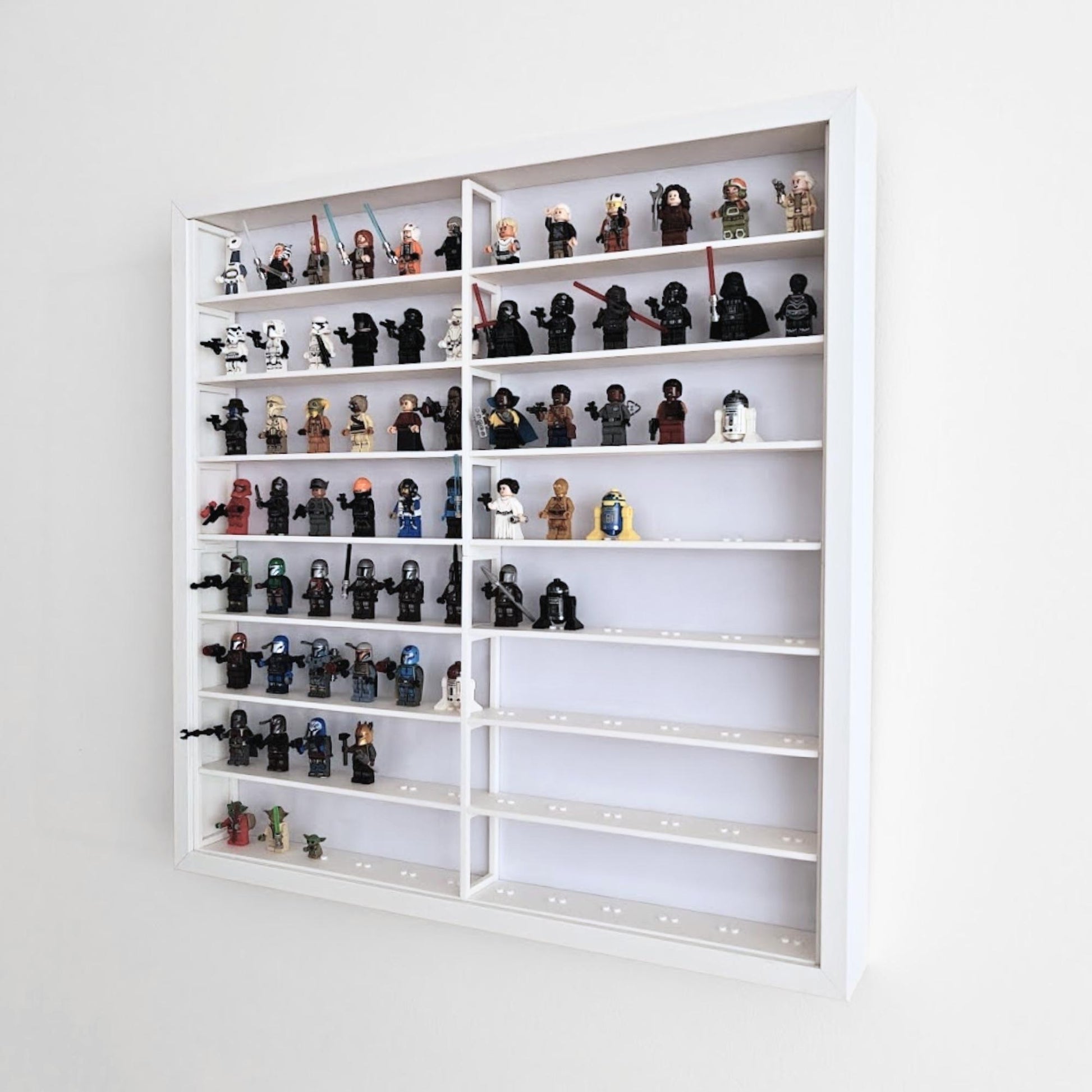 Angled side view of white LEGO display grid insert inside IKEA Sannahed frame filled with minifigures.