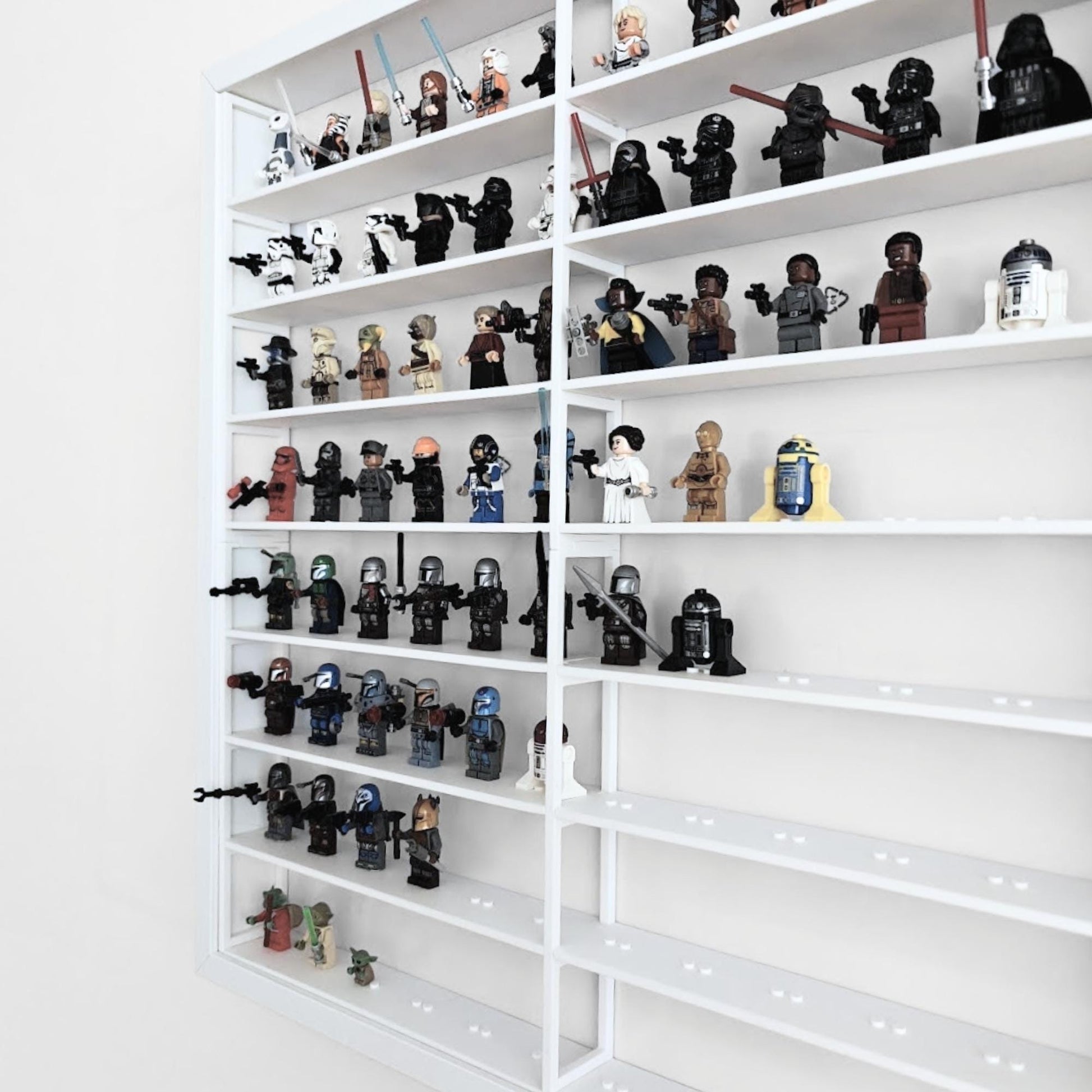 Angled side view of white LEGO display grid insert inside IKEA Sannahed frame filled with minifigures.