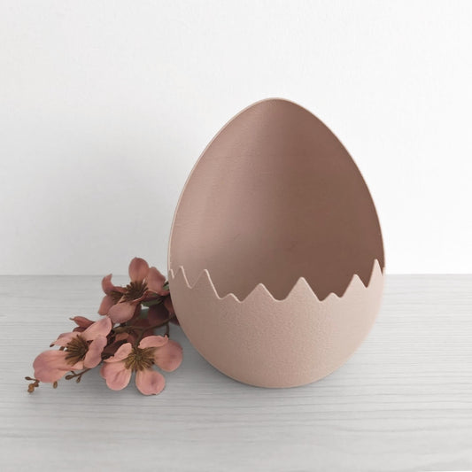 Empty cracked eggshell basket showing interior space for Easter eggs and decor