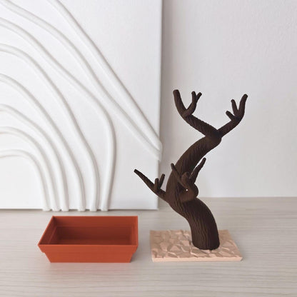 Bonsai holder components partially assembled with tree placed in base