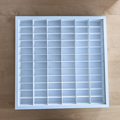 White grid insert for Sannahed frame placed on wooden surface