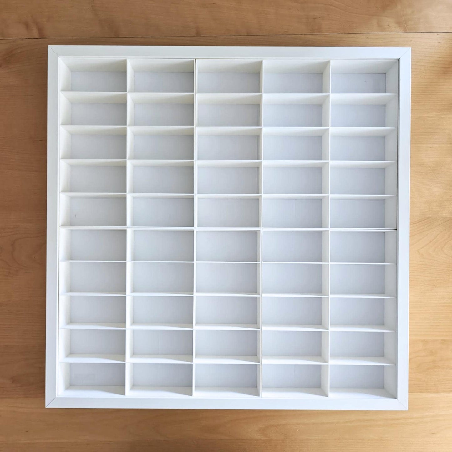 White grid insert inside frame showing empty compartments