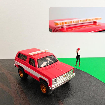 Red diecast SUV with white and transparent roof light bar mounted