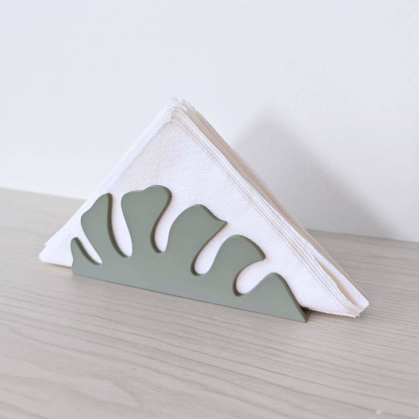 Napkin holder with folded white napkins