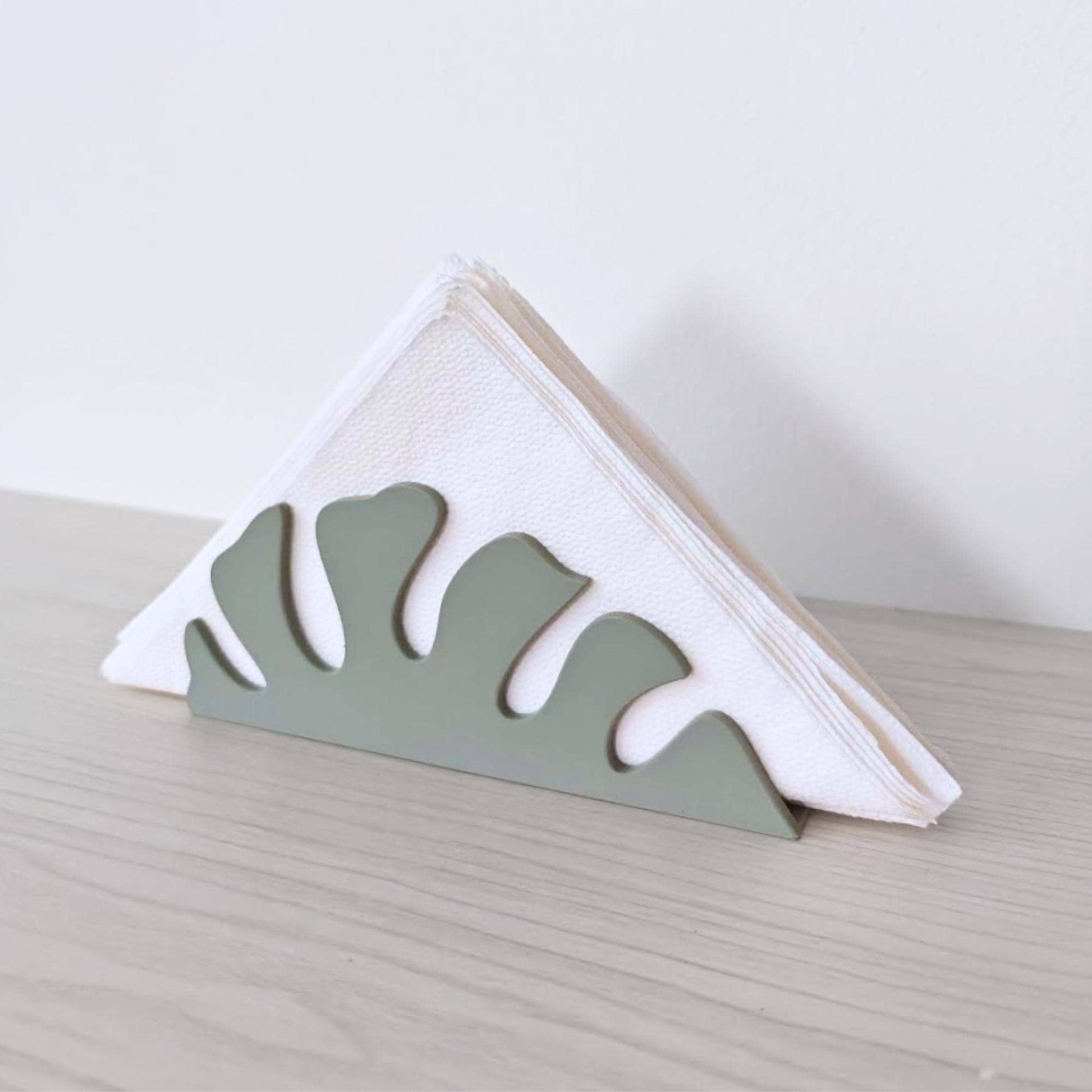 Napkin holder with folded white napkins