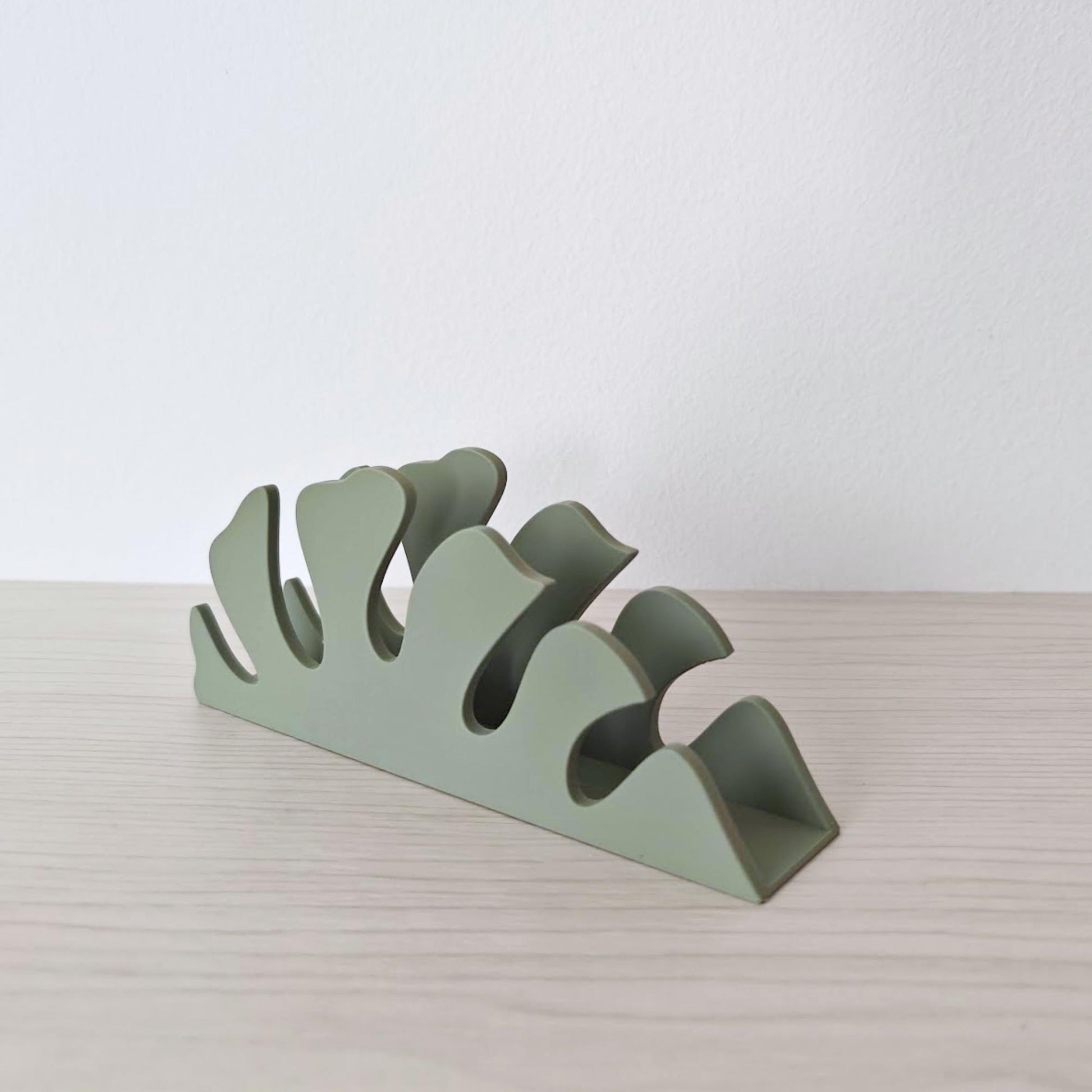 Angled view of monstera leaf napkin holder highlighting leaf shape design