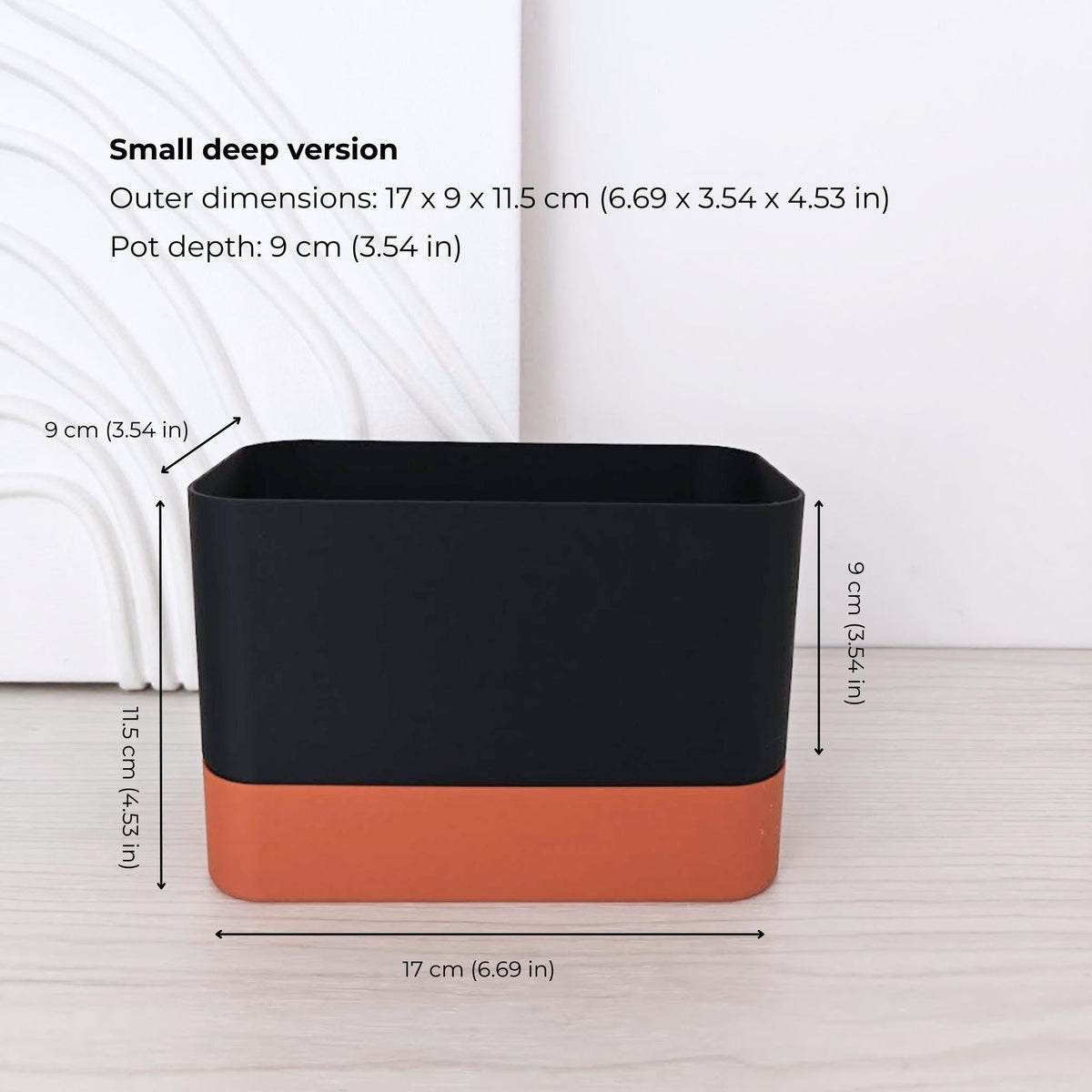 Small deep rectangular self-watering planter assembled in terracotta and black.