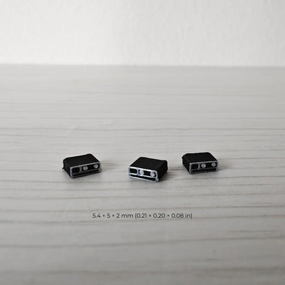 Close-up of three miniature emergency radios designed for firefighter and rescue dioramas.
