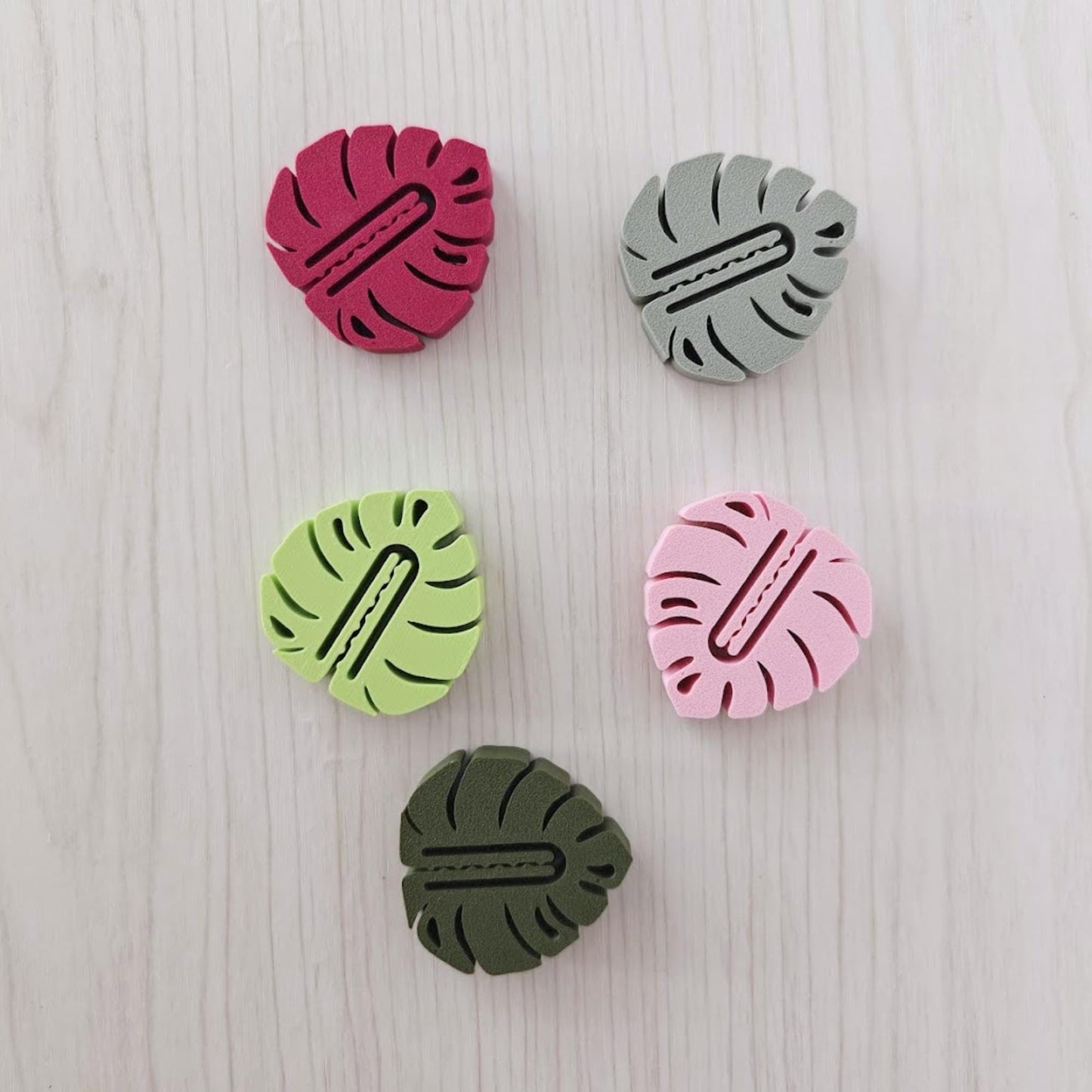 Set of five leaf-shaped bag clips in green, sage, pink, plum and bright green colors.