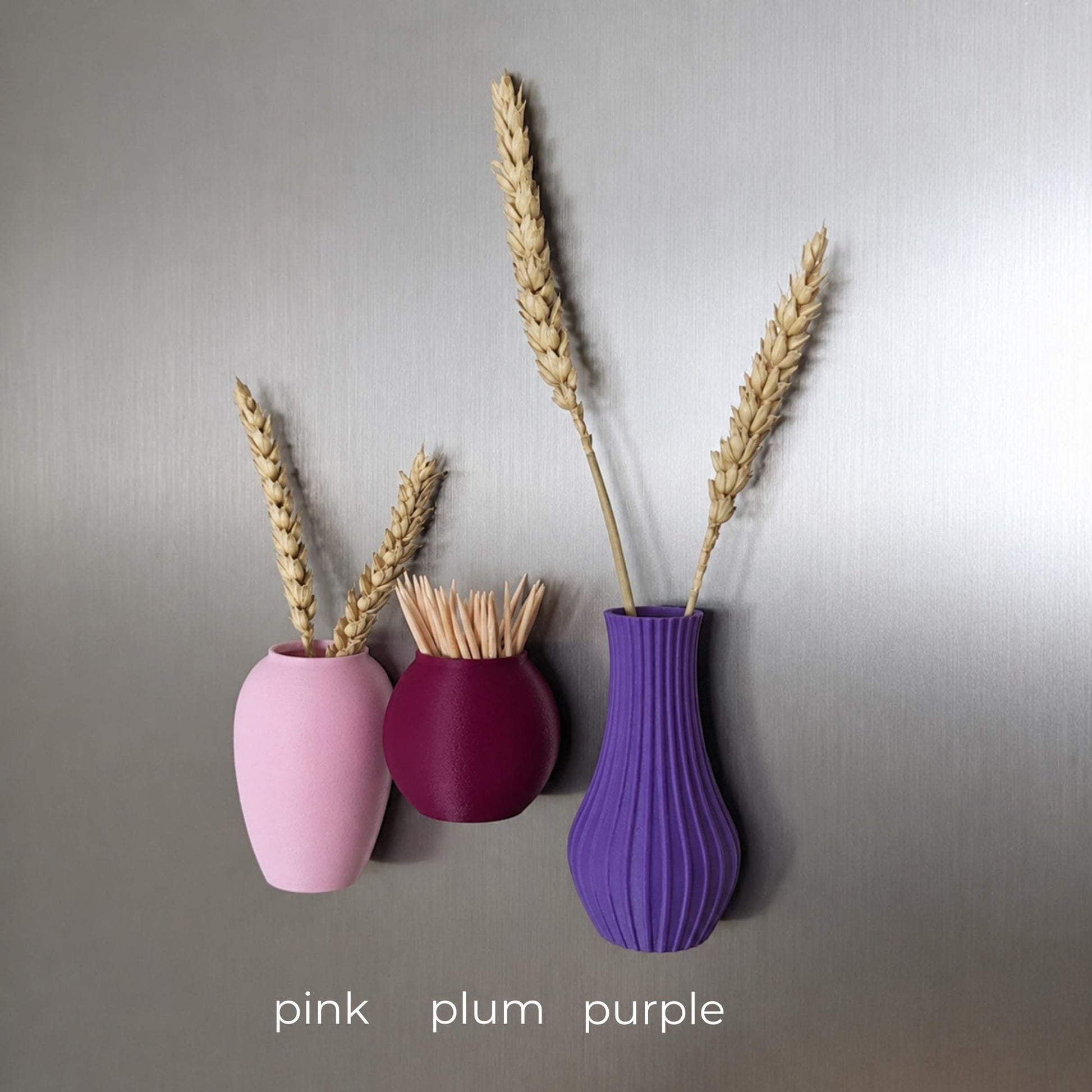 Three mini magnetic vases in various colors.
