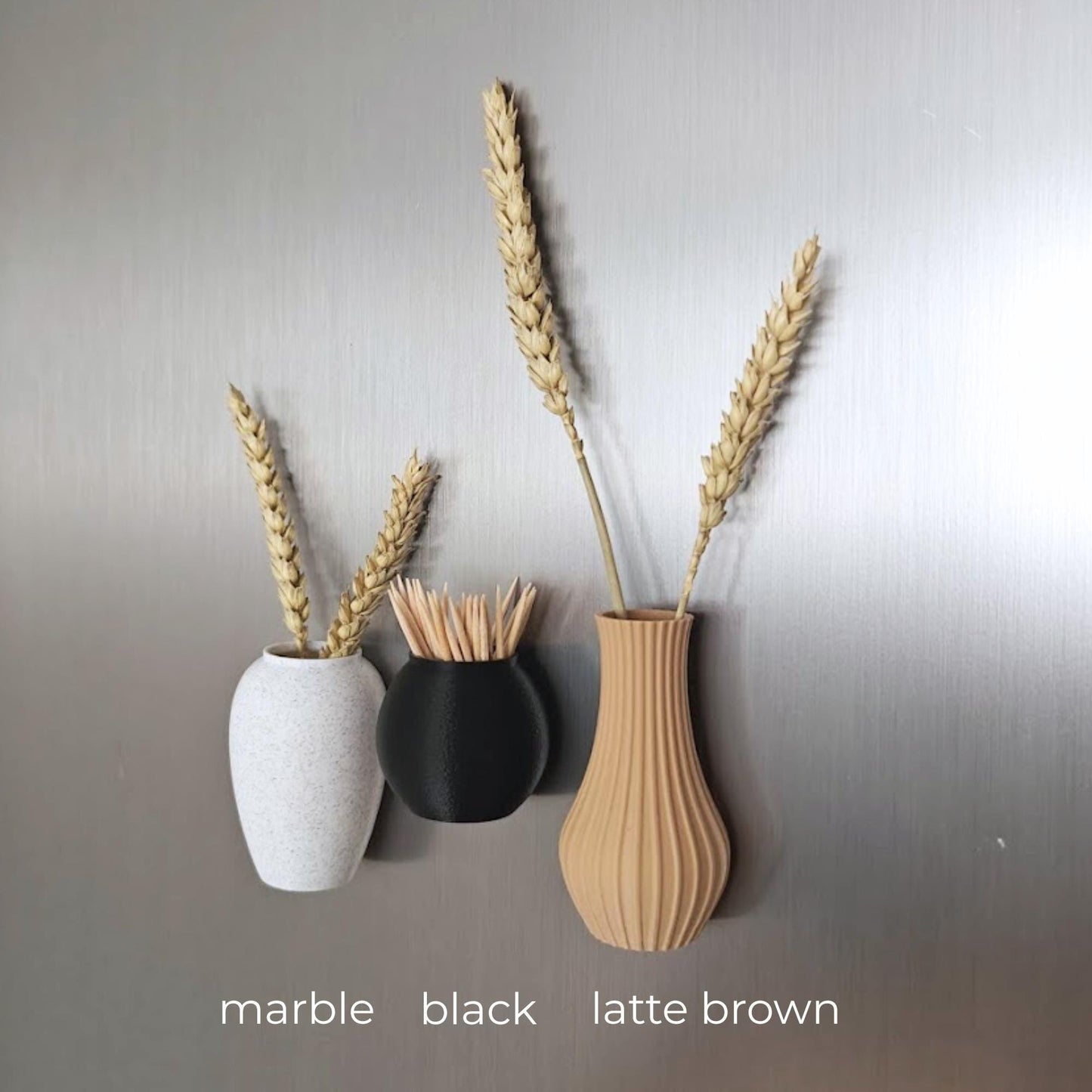 Three mini magnetic vases in various colors.