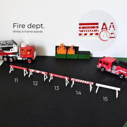 White fire department A-frame stands with red striped barricade bars for emergency scene displays