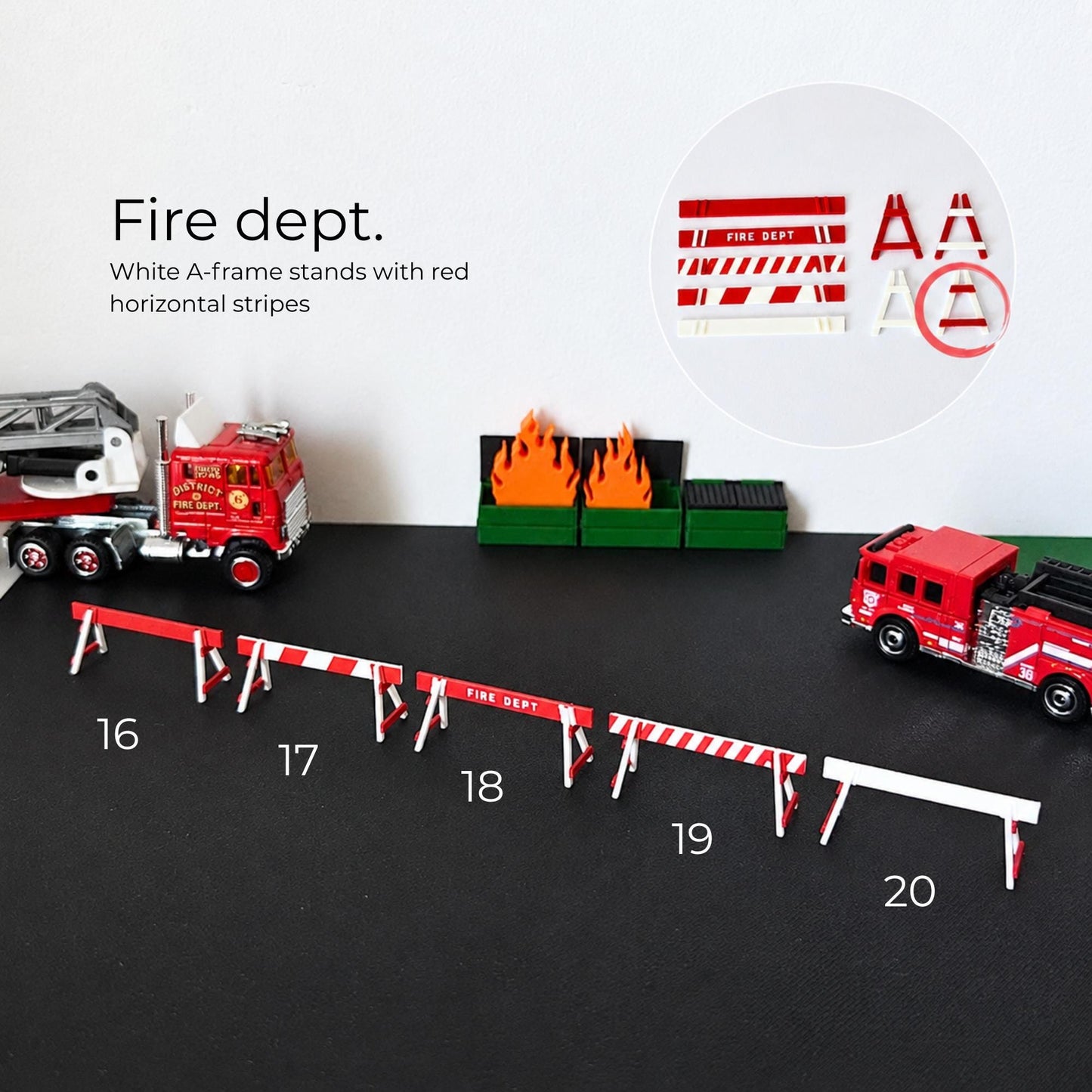 Red and white fire dept barricades arranged with miniature fire trucks and burning container props