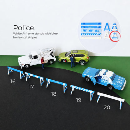 White and blue police barricades arranged as a miniature road closure scene with toy vehicles