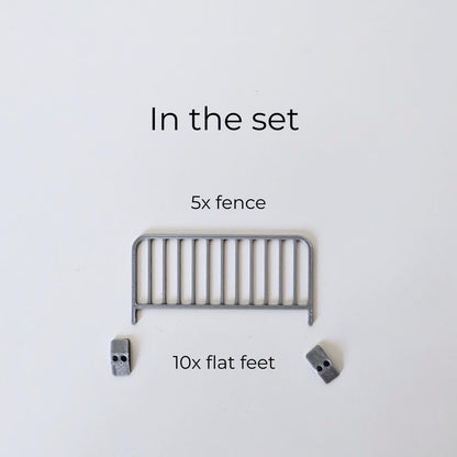 Set contents image showing 5 miniature fence panels and 10 flat feet for assembling crowd control barricades.