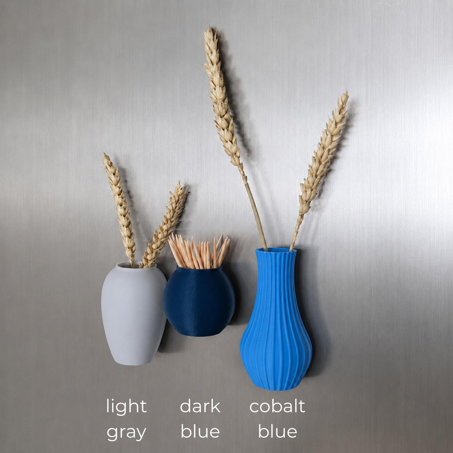 Three mini magnetic vases in various colors.