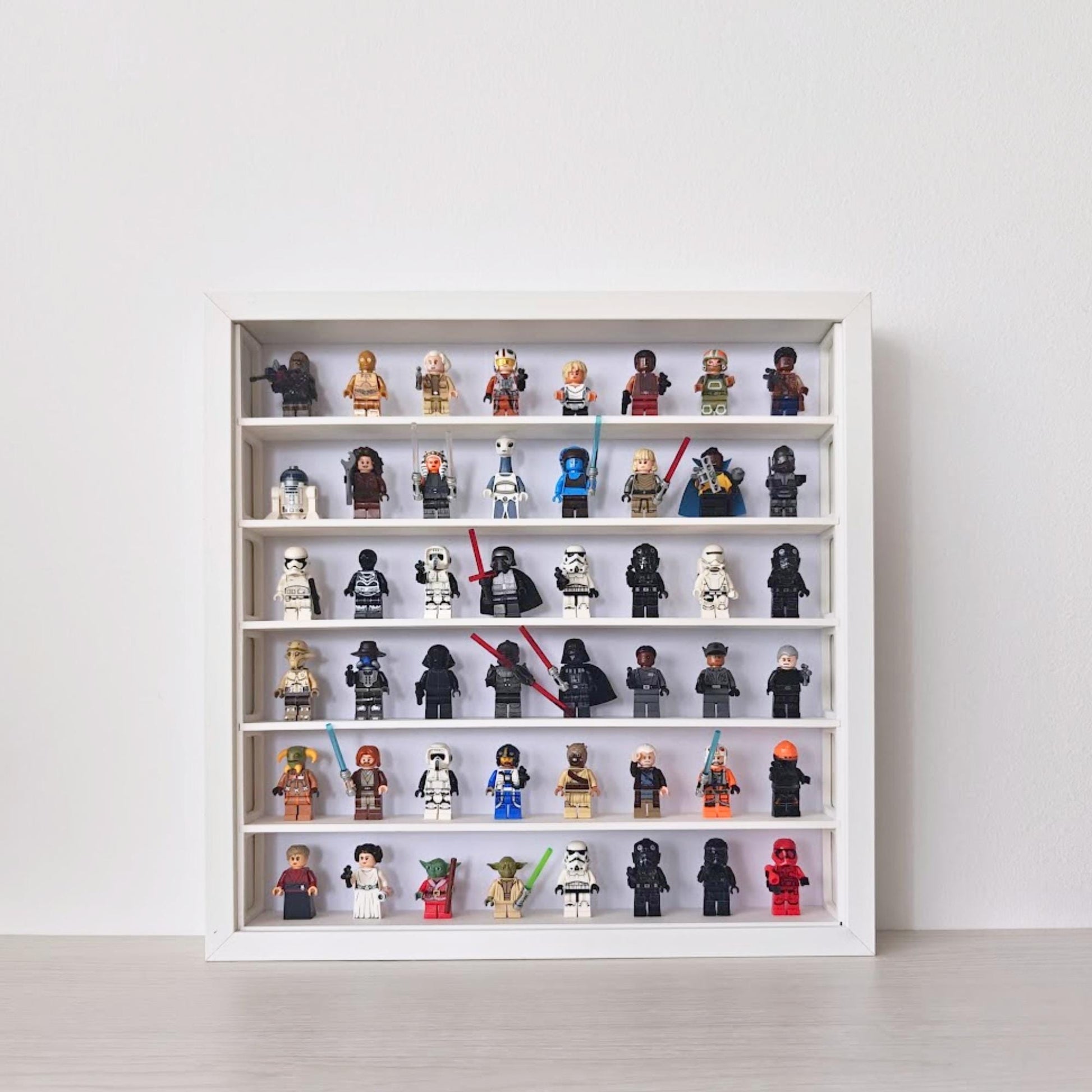 White SANNAHED 35 × 35 cm frame with a six-row display grid holding 48 collectible minifigures