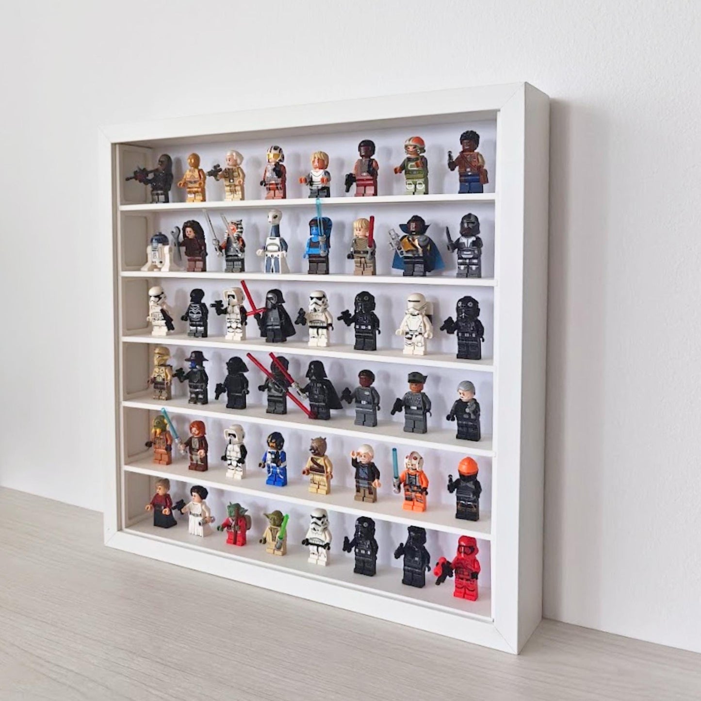 Angled view of the SANNAHED display frame filled with collectible minifigures on six shelves.