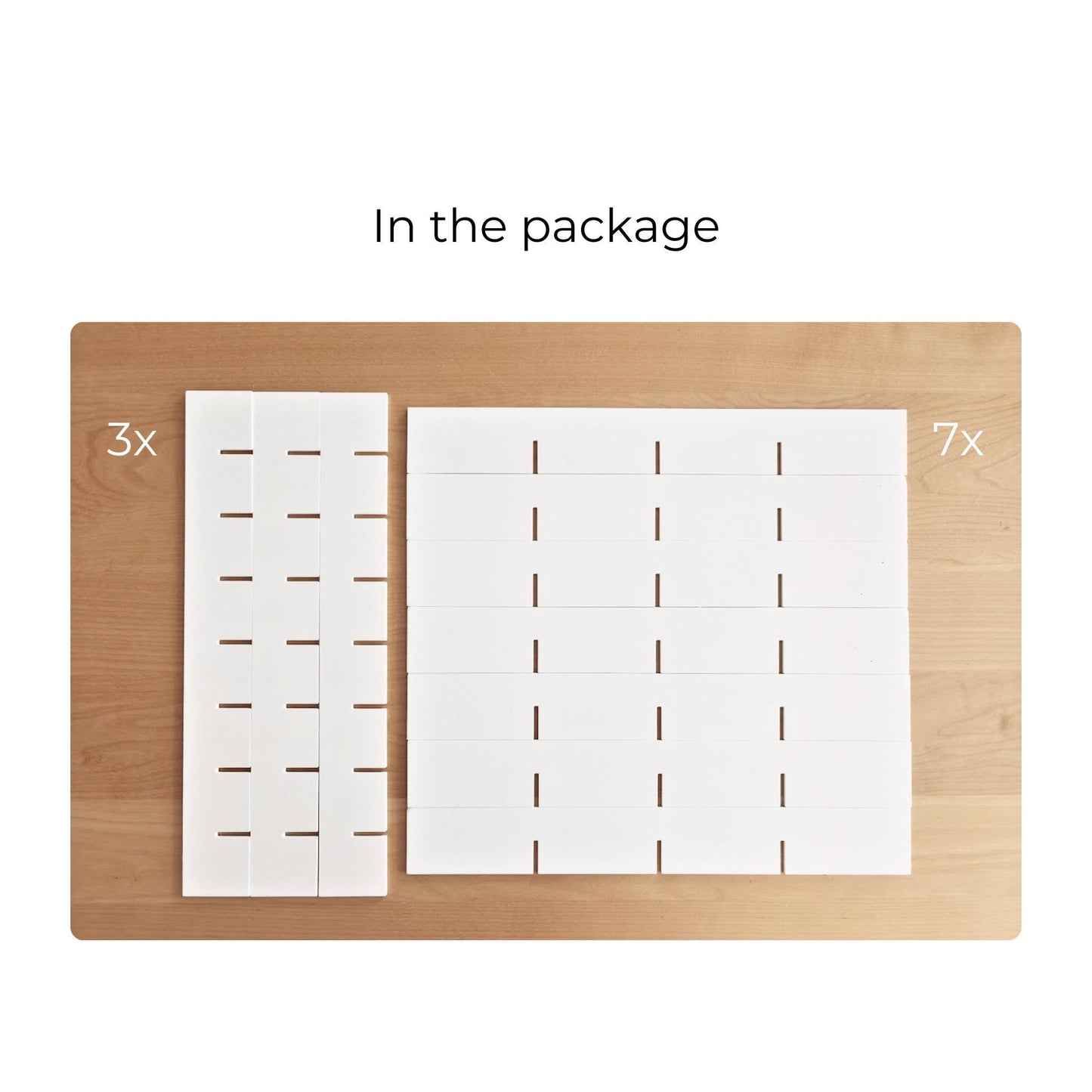 Package contents arranged on a wooden surface: three vertical divider pieces and seven horizontal shelf pieces.