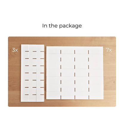 Package contents arranged on a wooden surface: three vertical divider pieces and seven horizontal shelf pieces.