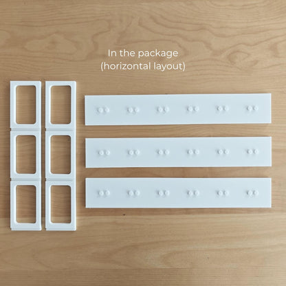 Parts included with the horizontal VÄSTANHED insert: side grid supports and three white display shelves.