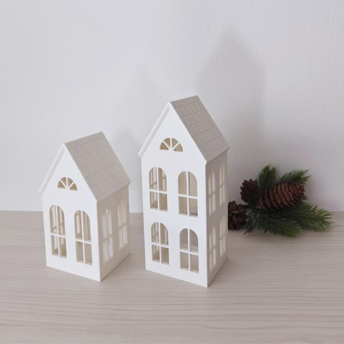 Angled view of small and tall house LED tealight holders
